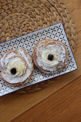 Two Italian fried Zeppole on a ceramic blue and white tray for St. Joseph (Father’s day)