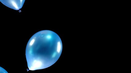 Watch as blue balloons gently fall on the left side of the screen, set against a striking black background. The contrast creates a dynamic and captivating visual effect.