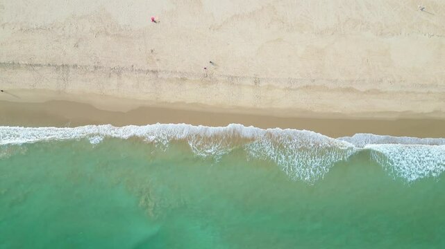 Serene beachscape of Praia de S&atilde;o Roque in Lagos, Portugal, with clear turquoise water