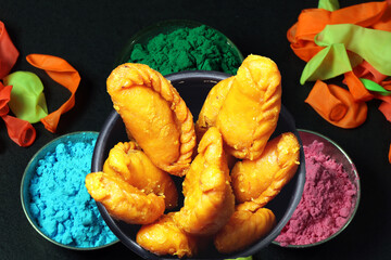 Gujiya or gujia is a popular North Indian sweet of flaky pastries with khoya, nuts stuffing.