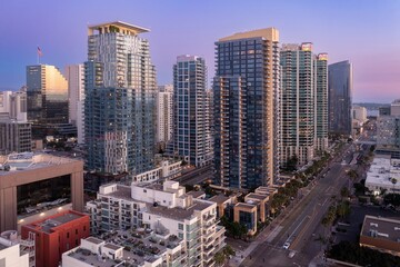 Obraz na płótnie Canvas Aerial view of downtown San Diego, California, USA, at dusk. Skyscrapers and city streets are visible, showcasing urban development and city life.