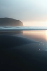 Obraz premium Serene coastal landscape with damp beach sand and gentle ripples at sunset