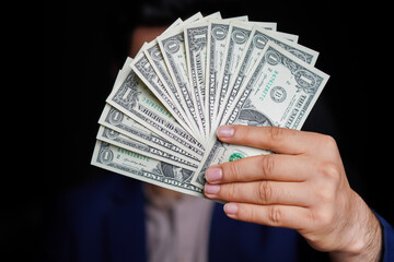 Businessman holding American dollar notes in hands