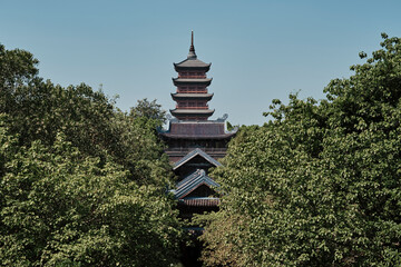Stunning view of a traditional Bai Dinh pagoda surrounded by lush greenery in Ninh Binh, Vietnam during a clear sunny day