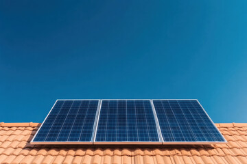 Fototapeta premium Solar panels generating clean energy on a rooftop under blue sky