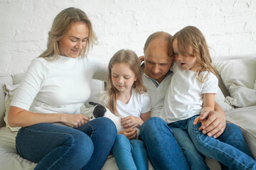 Cheerful family mother, father and children with little dog