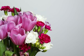Beautiful bouquet of fresh flowers on a gray background