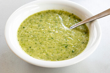 vibrant green spring soup made with fresh leek, spinach, and beans, served in a bowl