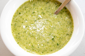 vibrant green spring soup made with fresh leek, spinach, and beans, served in a bowl