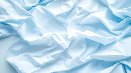 Obraz premium A crumpled plastic sheet on a smooth surface, offering a textured backdrop with space for minimalistic or product-related messaging.
