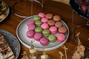 pink, red, brown macaroons, on the buffet table