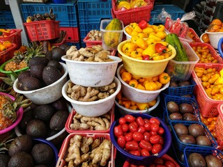 Fresh vegetable and fruit stall at De Haagse Markt or The Hague Market in Den Haag. Fresh ginger, tomato, paprika, avocado, pineapple