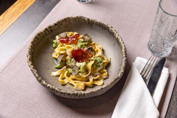 Creamy pasta with truffles, crispy bacon, and broccoli