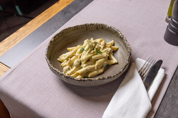 Gnocchi with steak and truffles on a plate in a restaurant