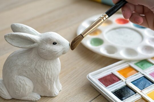 Hand paint rabbit statue with brush. Easter decor craft