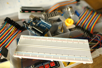 Electronics components, Breadboard in box with jumper wires and breadboard, symbolizing DIY...
