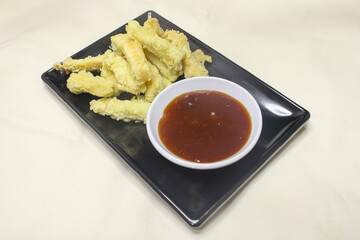 crispy fried bread food on black plate. menu for restaurant snacks