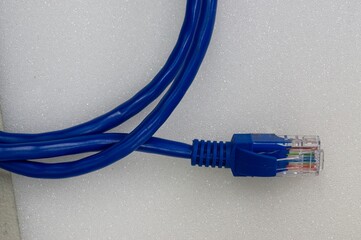 Ethernet patch cable rolled up on white