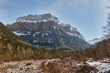 Fototapeta premium The Ordesa Valley, in the Ordesa and Monte Perdido National Park, completely covered in snow during winter. A stunning white landscape in the Pyrenees, offering breathtaking views of the untouched wil