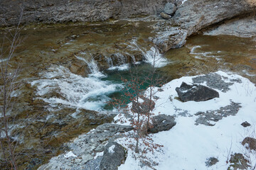 The Estrecho Waterfall, surrounded by snow in winter, in the Ordesa Valley, within Ordesa and Monte...