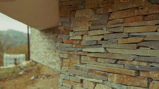 Modern architecture featuring a stone cladding wall with varying colors and textures