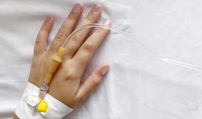 Peripheral Catheter for Multiday Therapy on female hand in hospital, medicine background