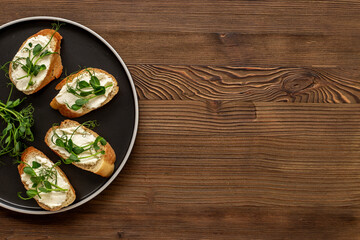 Plate of sandwiches with cream cheese and micro greens peas. Healthy food, top view