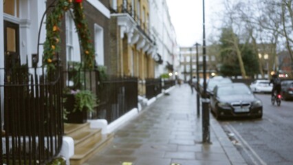 Blurred london street scene in winter with defocused cars, buildings, and trees, capturing a quiet and moody urban atmosphere in the united kingdom.