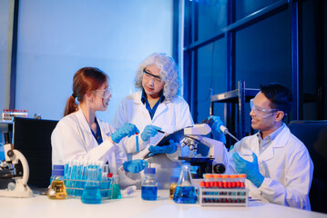 Scientists in lab coats collaborating with test tubes, flasks, and microscopes in a modern lab.