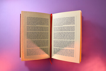 Fototapeta premium Open book written with log tape isolated with purple background