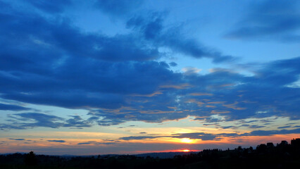 Beautiful sunset sky in a rural village Gliczarow Gorny, Poland, Europe. Clouds on blue orange sky. Tatra mountains in the background