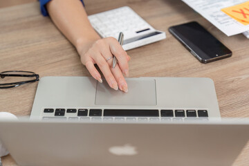 Business Administration and Tax Preparation. A professional engaging in business tasks at a laptop,...