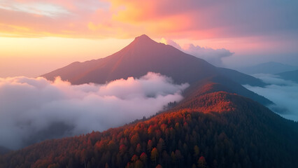 Fototapeta premium Aerial View of Mountain Peak in Sunlight and Fog at Sunset – Majestic and Breathtaking Scene 