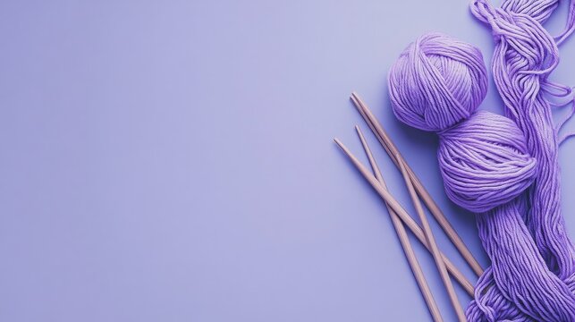 Soft purple yarn and knitting needles on a lavender background. Perfect for a cozy and relaxing project.