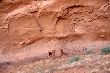 Old Native American home at the foot of a rocky mountain