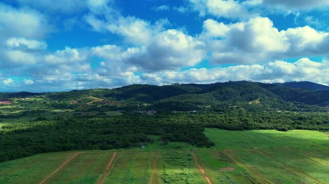 Aerial View of Green Hills and Scenic Landscape Under a Blue Sky