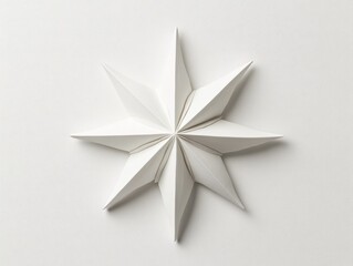 Elegant white paper star design on a clean surface.