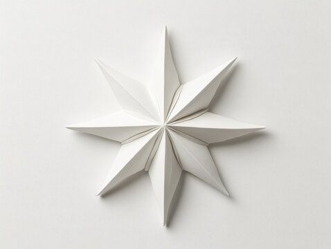 Elegant white paper star design on a clean surface.