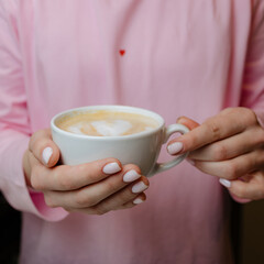 Warm Coffee With Heart Design in Hands at Cozy Cafe on a Tranquil Morning