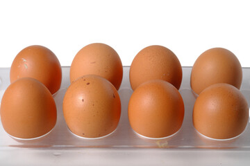 Brown chicken eggs arranged in plastic tray, showcasing their natural texture isolated transparent Background.