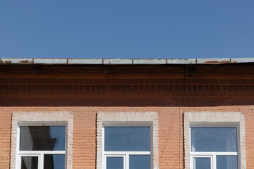 Beautiful Sunny Day Highlighting a Vintage Brick Building With White Windows in an Urban Setting