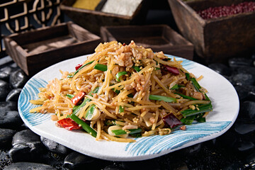 Fried shredded potatoes with chives, garlic slices, millet peppers