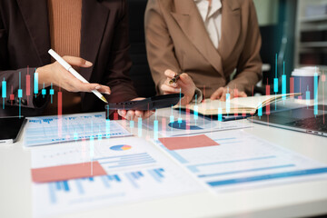 Businessmen team or financial data analysts working with tablets and laptop computers and data...