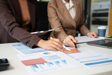 Businessmen team or financial data analysts working with tablets and laptop computers and data graphs together. Plan to analyzing projects in the office..