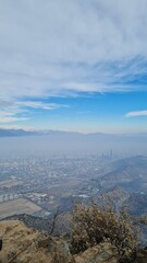 Fototapeta premium A stunning panoramic view of Santiago city with the Andes mountains in the background, captured from a hilltop. Urban landscape meets natural beauty in Chile.