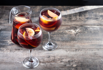Refreshing Summer Citrus Fruit Sangria in crystal jar on wooden table. Copy space