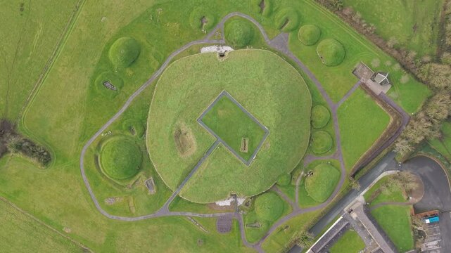 Ancient Knowth passage tomb, aerial view, lush green landscape, Irish heritage site