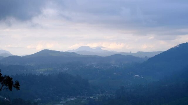 Panoramic aerial view overlooking Haputale in highlands of Sri Lanka with rugged mountainous terrain and low clouds