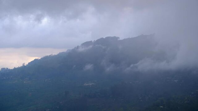 Cloudy weather conditions rolling over rugged mountainous terrain in Haputale highlands of Sri Lanka
