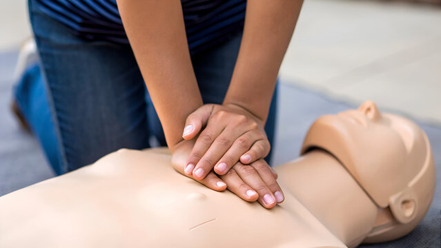 basic CPR training resuscitation emergency breathing Performing CPR on a mannequin to practice lifesaving techniques.